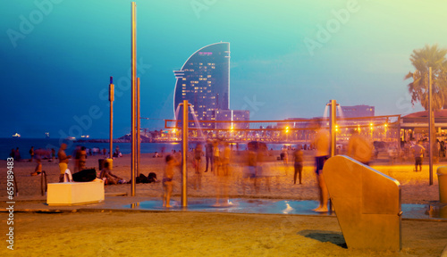 View of Barceloneta beach in night on background with luxury hotel in Barcelona photo