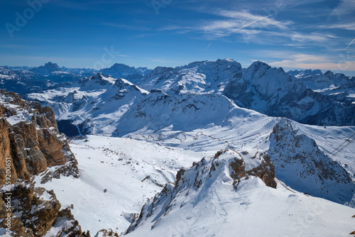 View of a ski resort piste and Dolomites mountains in Italy from Passo Pordoi pass. Arabba, Italy