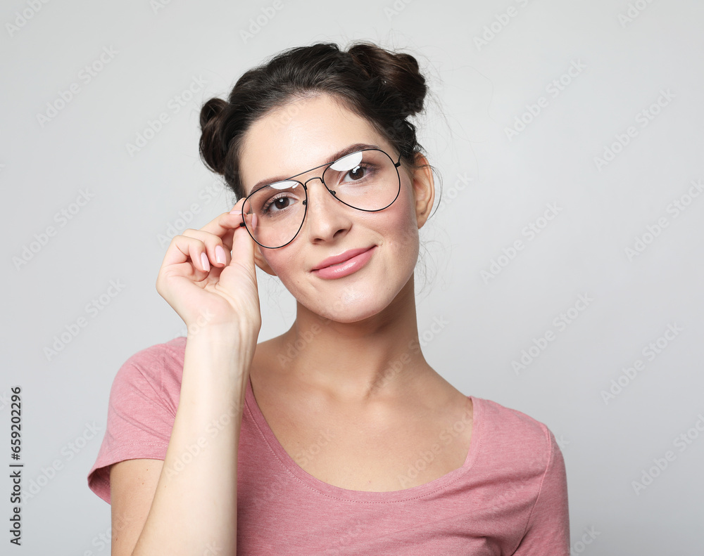 Pretty smiling female dressed casually, looking with satisfaction at camera, being happy. Pretty smiling female dressed casually, looking with satisfaction at camera, being happy.