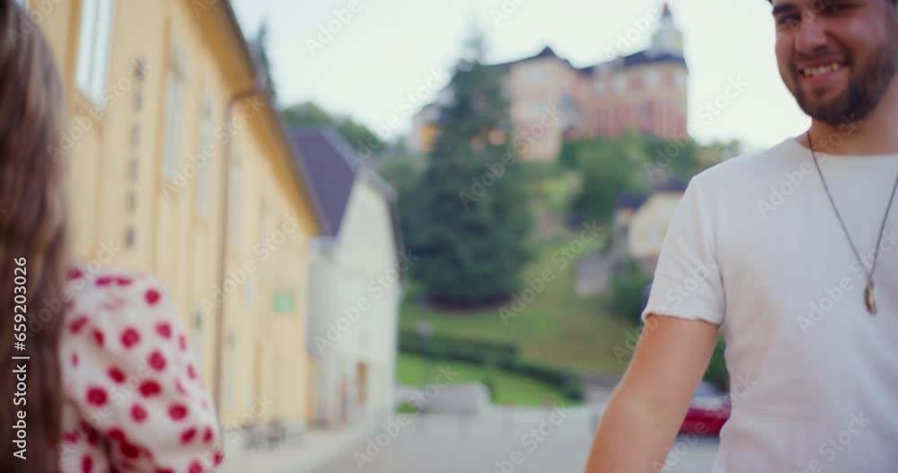 Woman laughing and talking with boyfriend on footpath Woman laughing and talking with boyfriend on footpath