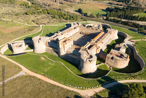 Picturesque autumn landscape with imposing medieval fortified Chateau de Salses, French Catalonia photo