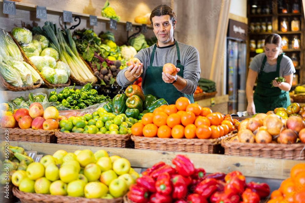 Supermarket employee will lay out ripe fruits and vegetables on the counter