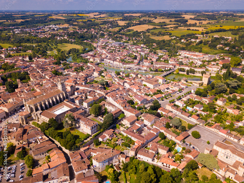 View from drone of modern cityscape of French commune of Condom on river Baise in summer