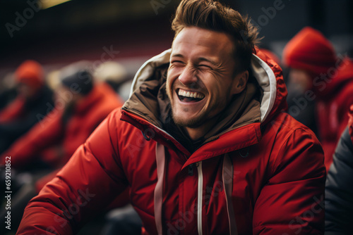 A fan in a football stadium laughing