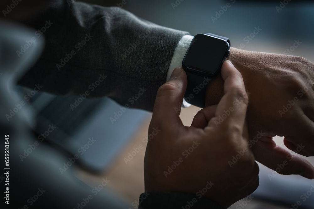 Man checking time on his smartwatch device Close-up display clock checking lifestyle communication phone mobile touch app technology