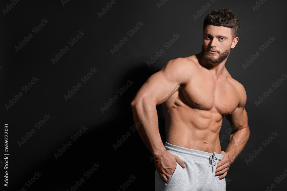 Fototapeta premium Handsome muscular man on black background, space for text. Sexy body