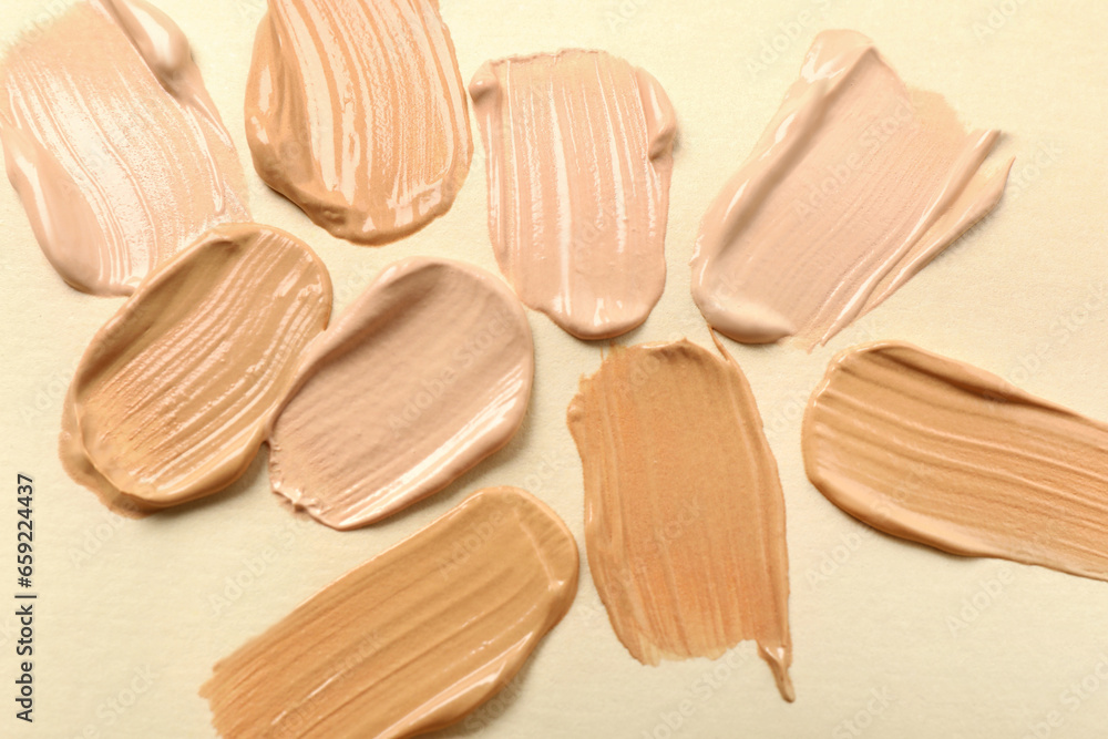 Samples of skin foundation on beige background, top view Samples of skin foundation on beige background, top view