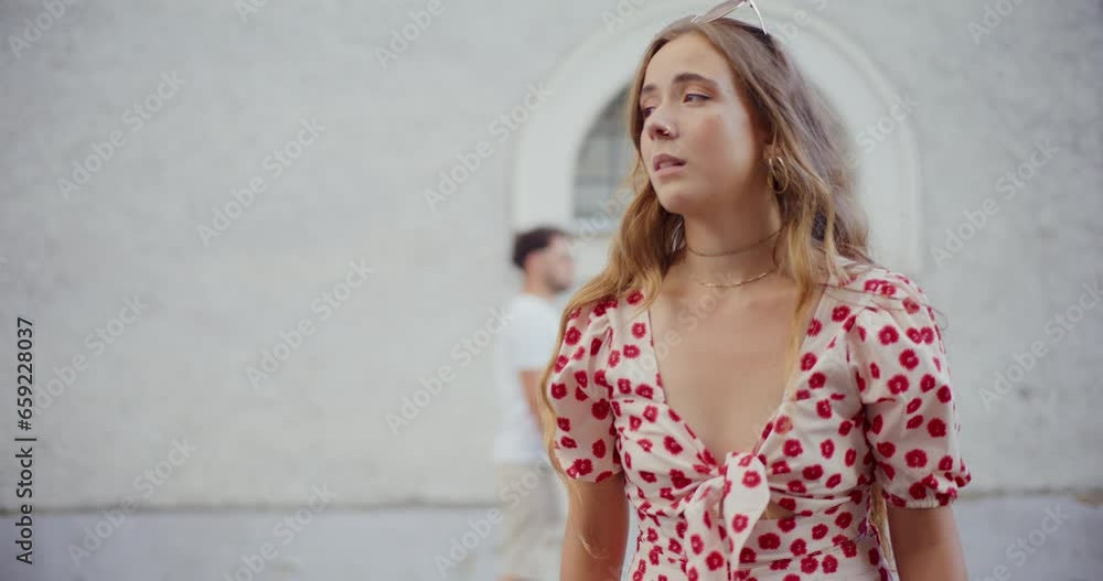 Blond woman searching someone against building Blond woman searching someone against building