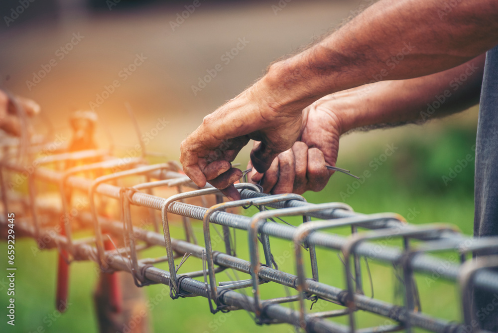 Construction Men hands bending cutting steel wire fences bar