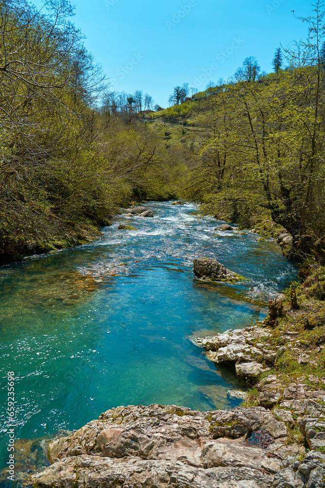 The natural pool of the mountain river with emerald clear water The natural pool of the mountain river with emerald clear water