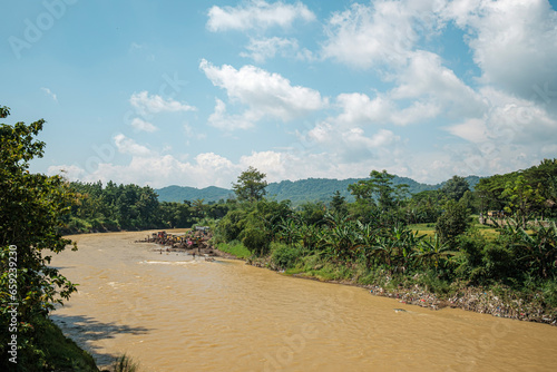 rustic riverside scene with green trees 