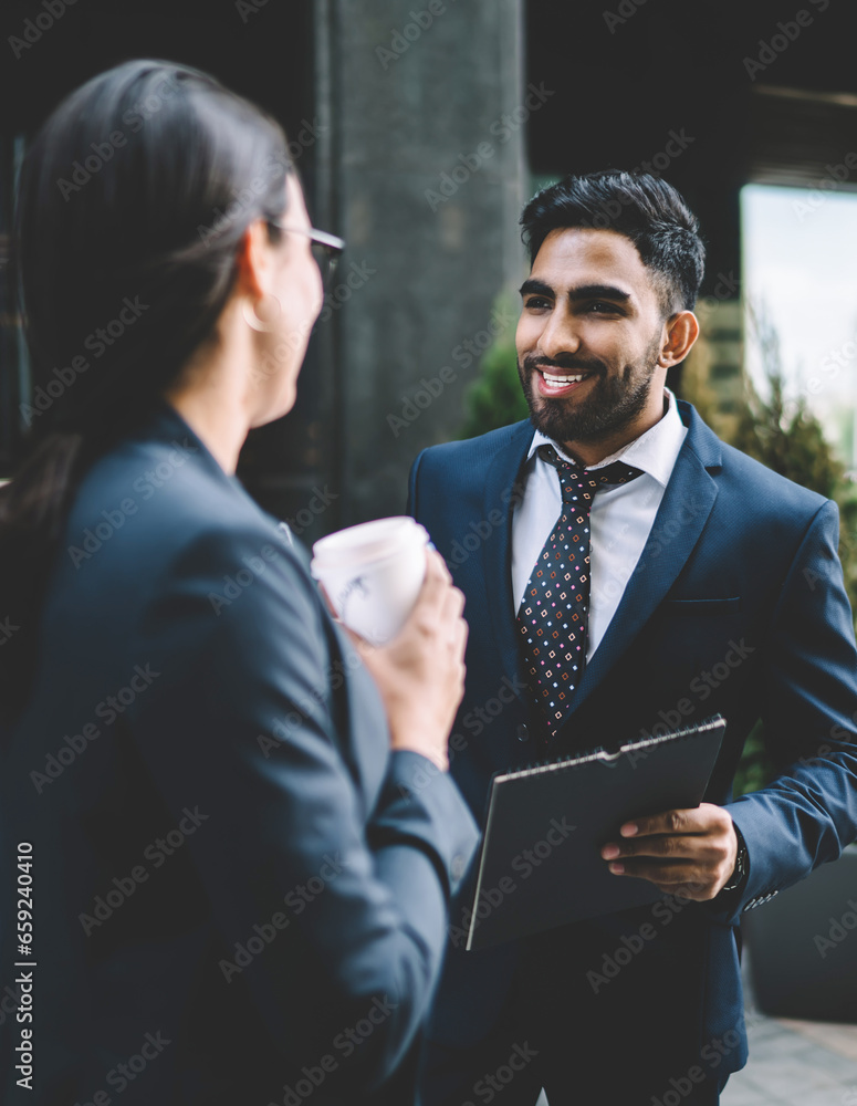 © BullRun - Delighted colleagues having discussion in street