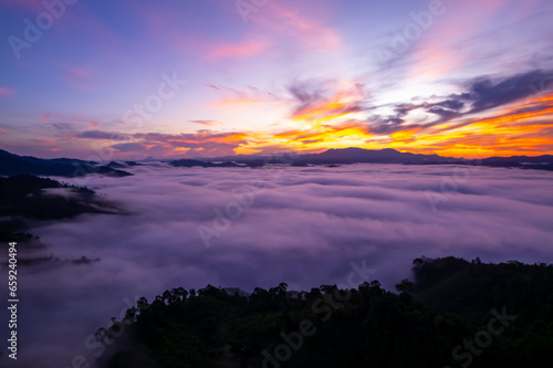 Amazing Sunrise or sunset over mountains hills covered with mist, Aerial view landscape drone shot beautiful colorful nature background © panya99