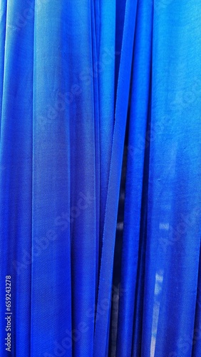 Blue curtain close up. Abstract background and texture for design with copy space.