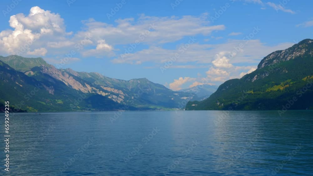 Travel on Lake Brienz with Mountain View in a Sunny Summer Day with Blue Sky and Clouds in Interlaken, Bernese Oberland, Bern Canton, Switzerland, Europe Travel on Lake Brienz with Mountain View in a Sunny Summer Day with Blue Sky and Clouds in Interlaken, Bernese Oberland, Bern Canton, Switzerland, Europe