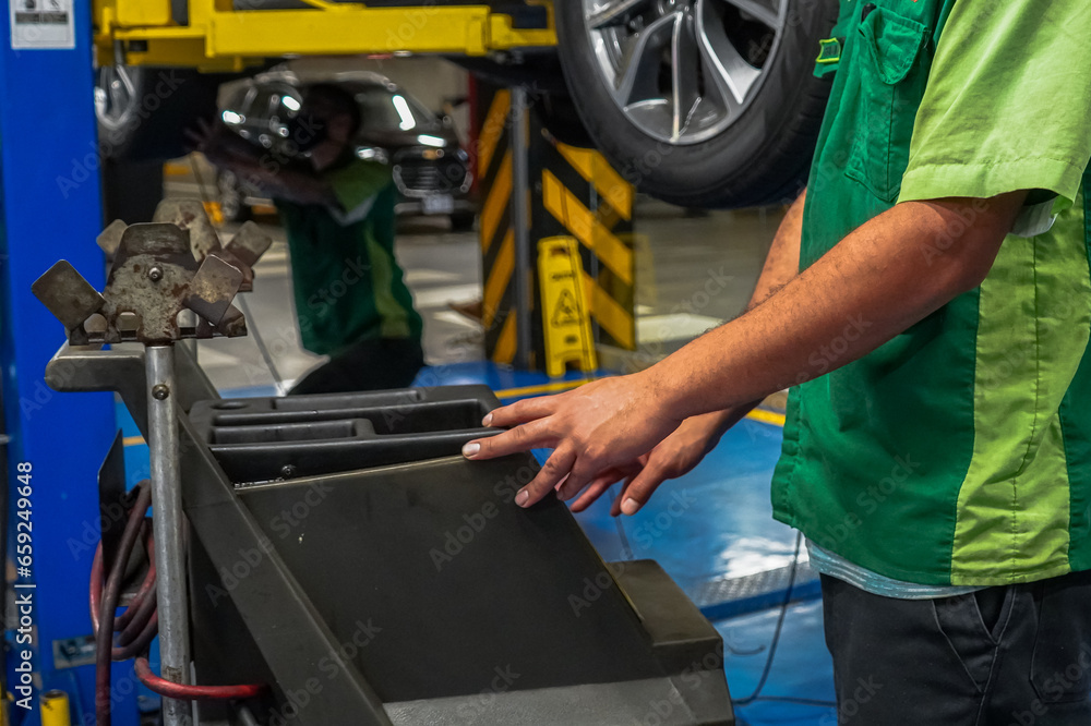 Close up view of a Maintenance Car service - auto oil change, motor check, brake cleaning, tire check, engine inspection, motor oil-brake inspection Close up view of a Maintenance Car service - auto oil change, motor check, brake cleaning, tire check, engine inspection, motor oil-brake inspection