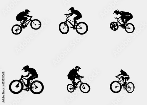 Fototapeta Naklejka Na Ścianę i Meble -  Silhouette of boys riding a bmx bicycle
