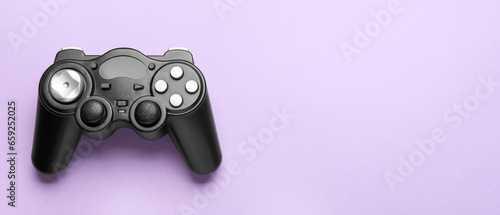 Modern controller on lilac background with space for text