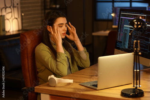 Tired female programmer wor...