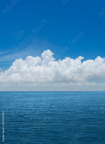 White cumulus clouds above blue Ocean