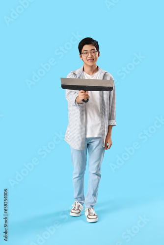 Young Asian man with putty ...