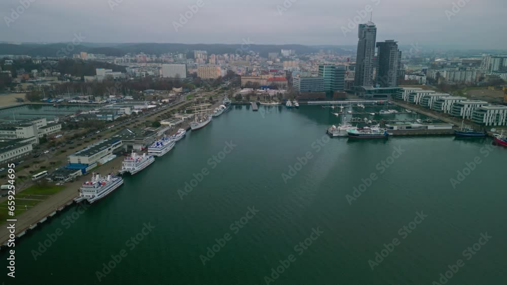 Aerial View Perspective of the Vibrant Gdynia Port, as Ships Unload their Precious Cargo. Breathtaking Drone View of the Linking the City to the Maritime. Aerial View Perspective of the Vibrant Gdynia Port, as Ships Unload their Precious Cargo. Breathtaking Drone View of the Linking the City to the Maritime.