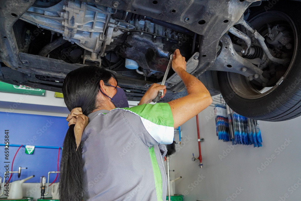 Close up view of a Maintenance Car service - auto oil change, motor check, brake cleaning, tire check, engine inspection, motor oil-brake inspection Close up view of a Maintenance Car service - auto oil change, motor check, brake cleaning, tire check, engine inspection, motor oil-brake inspection