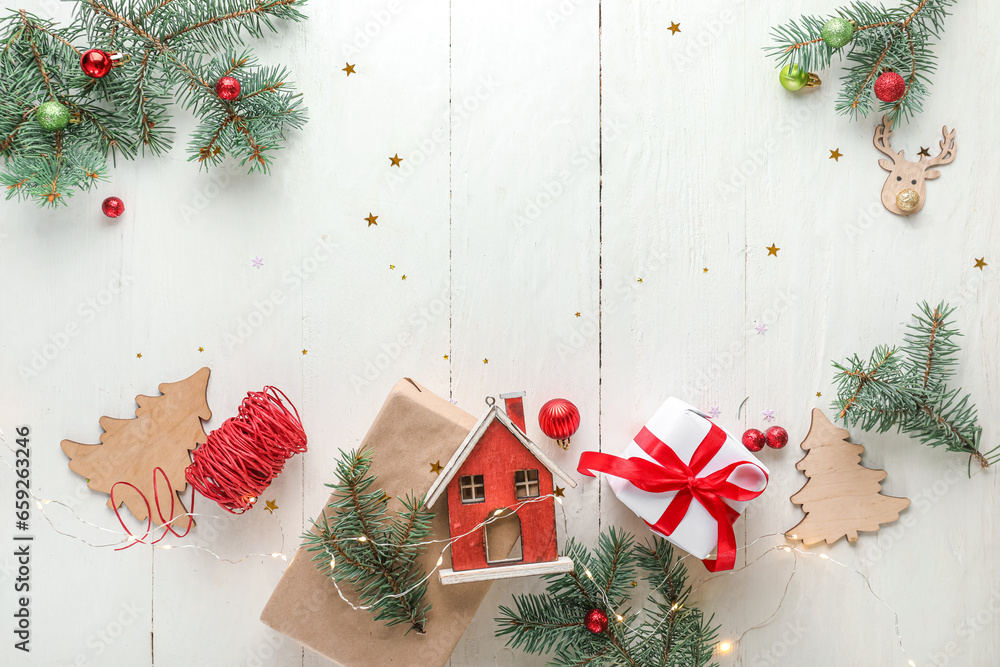 Christmas lights, gift box, toy house and decor on white wooden background - obrazy, fototapety, plakaty 