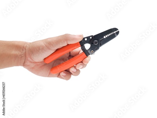 Male hand holding wire stripping pliers with orange handles isolated on white background.