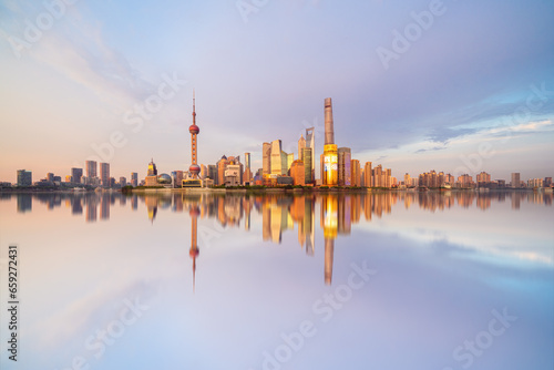 Illuminated Shanghai Skyline Reflecting On River	
