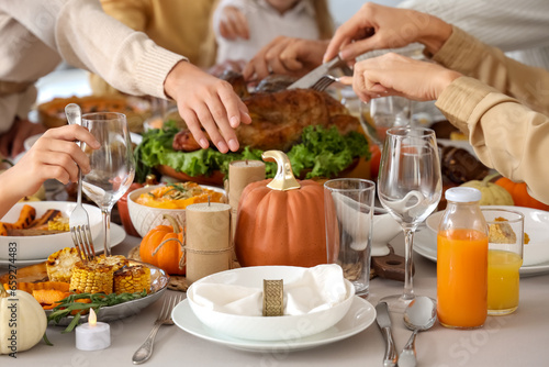 Happy family having dinner at festive table on Thanksgiving Day  closeup