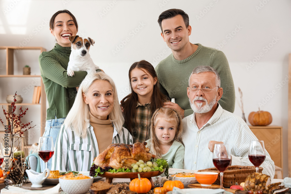Happy family having dinner at festive table on Thanksgiving Day Happy family having dinner at festive table on Thanksgiving Day