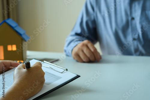 Businessman signs contract makes a detailed agreement, business contract. Businessman documents, approval, customer signs home purchase agreement, home insurance contract. Business project insurance.
