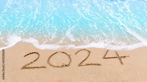 2024 new year goals planning concept. Numbers 2024 on brown sand and blue ocean waves. Top view.Investment in 2024. Copy space for your design or text. Wallpaper background