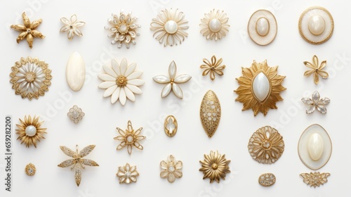 A collection of 24 vintage gold and pearl brooches on a white background. The brooches are in various shapes and sizes, such as flowers, leaves, and stars. The brooches are arranged in a symmetrical