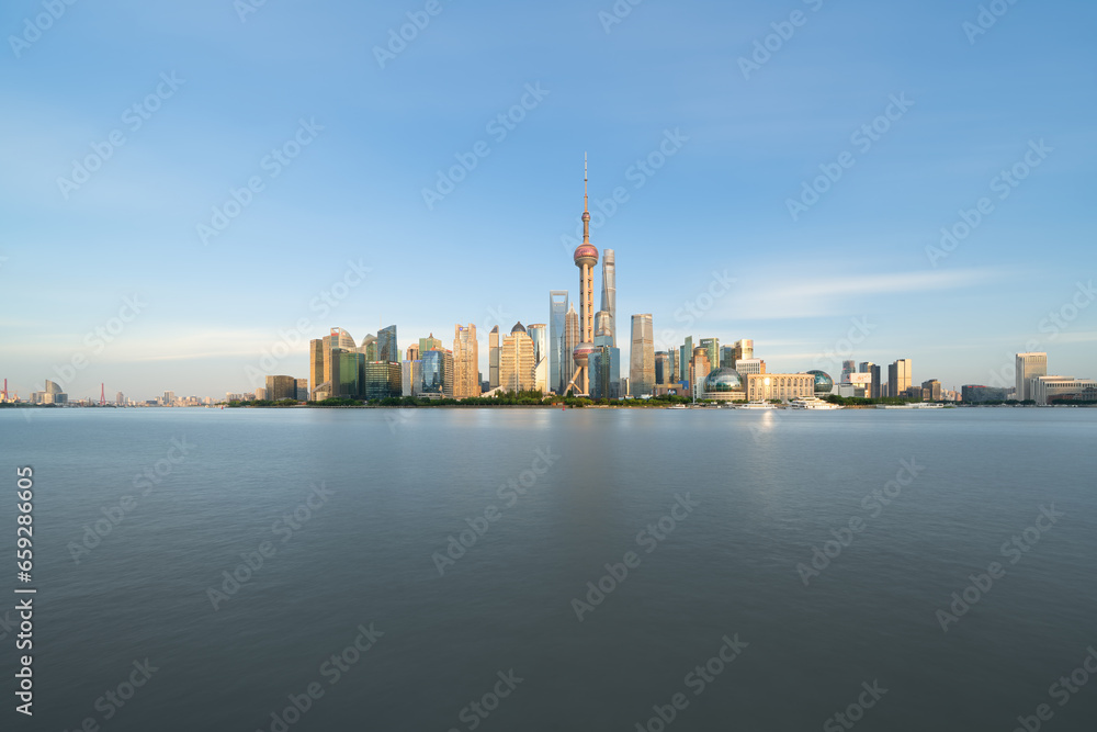 Illuminated Shanghai Skyline Reflecting On River	
