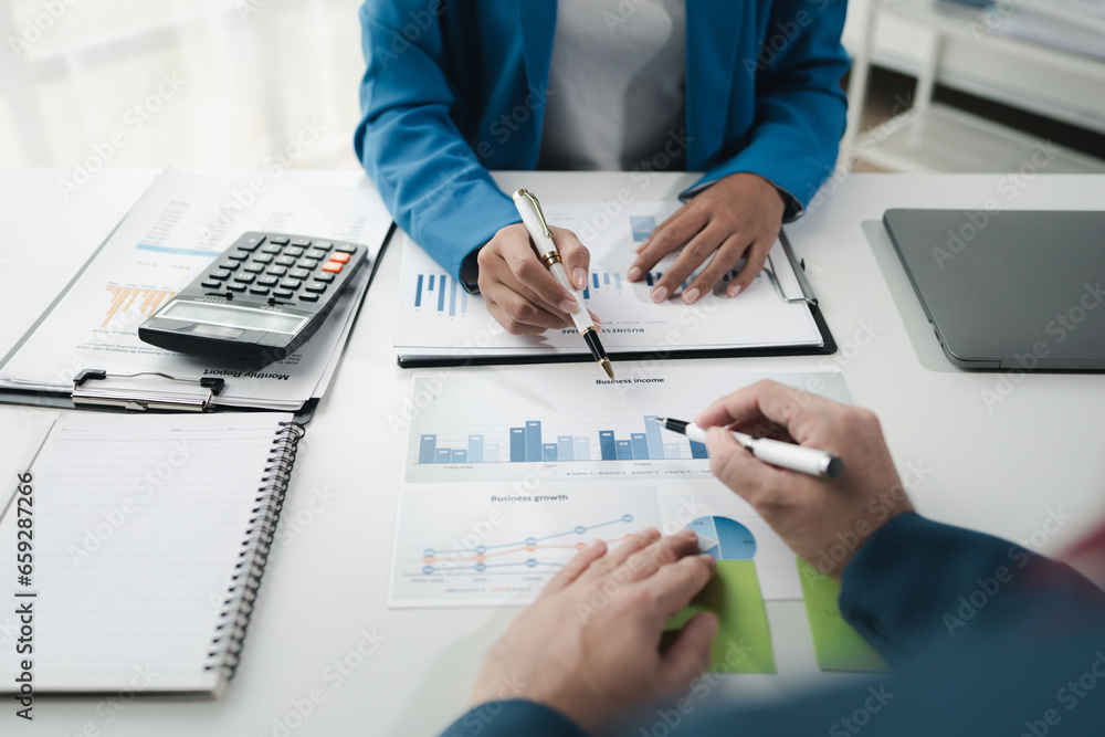 Finance and Marketing Business Meeting, Two businessmen are meeting together and looking at financial and marketing documents to plan how to grow their business. Business meeting concept. Finance and Marketing Business Meeting, Two businessmen are meeting together and looking at financial and marketing documents to plan how to grow their business. Business meeting concept.