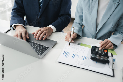 Finance and Marketing Business Meeting  Two businessmen are meeting together and looking at financial and marketing documents to plan how to grow their business. Business meeting concept.