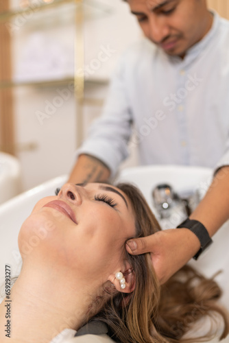 Woman receiving a hair massage while washing hair