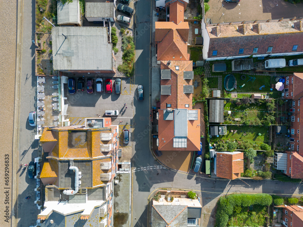 Drone top down view of a large air ventilation duct seen atop a large restaurant and hotel located along a popular Suffolk, UK coastal resort.