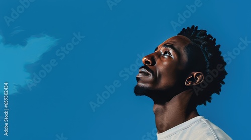 Portrait of a Mature Black Man Looking Left on a Blue Background- generative AI, fiction Person