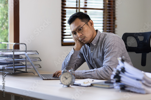 Asian man stressed while working, Sad, unhappy, Worried, Depression, or employee life stress concept