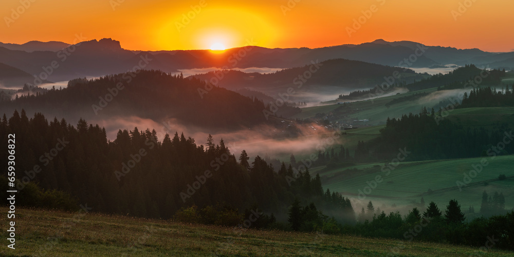 Beautiful sunrise in the picturesque mountains. Picturesque mists rolling in the valleys illuminated by the rays of the rising sun,Pieniny,Poland