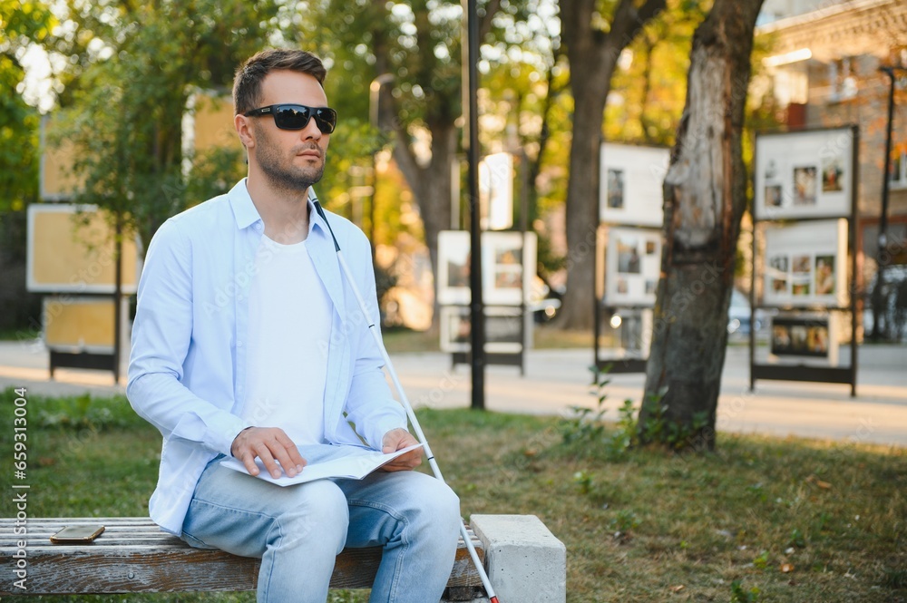 Blinded man reading by touching braille book Blinded man reading by touching braille book