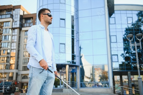 Blind man. Visually impaired man with walking stick,