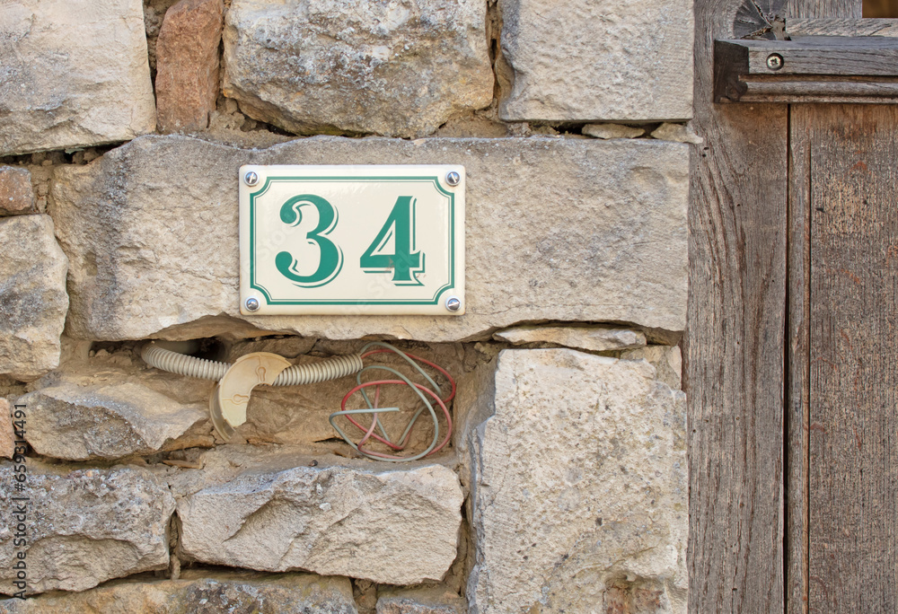 Stone wall near a door, entrance to number 34 Stone wall near a door, entrance to number 34