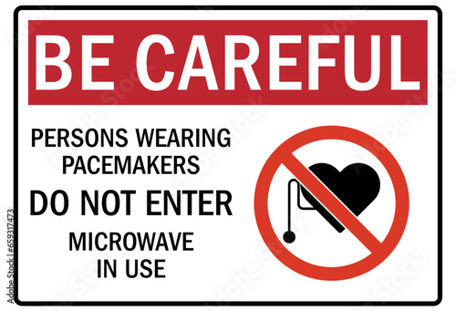 Pacemaker and magnetic hazard warning sign and labels persons wearing pacemakers do not enter. Microwave in use