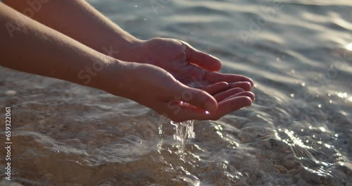 Woman female hands scoop crystal clear clean sea water beach close up