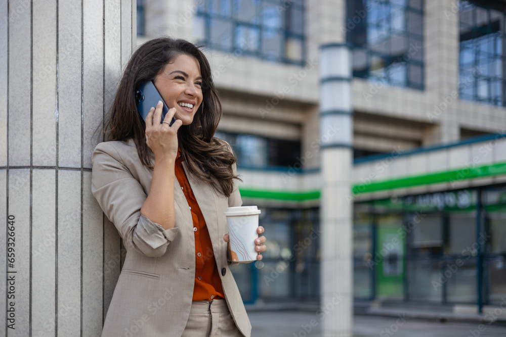 Beautiful Woman Going To Work With Coffee Walking Near Office Building. Portrait Of Successful Business Woman Holding Cup Of Hot Drink. Beautiful Woman Going To Work With Coffee Walking Near Office Building. Portrait Of Successful Business Woman Holding Cup Of Hot Drink.