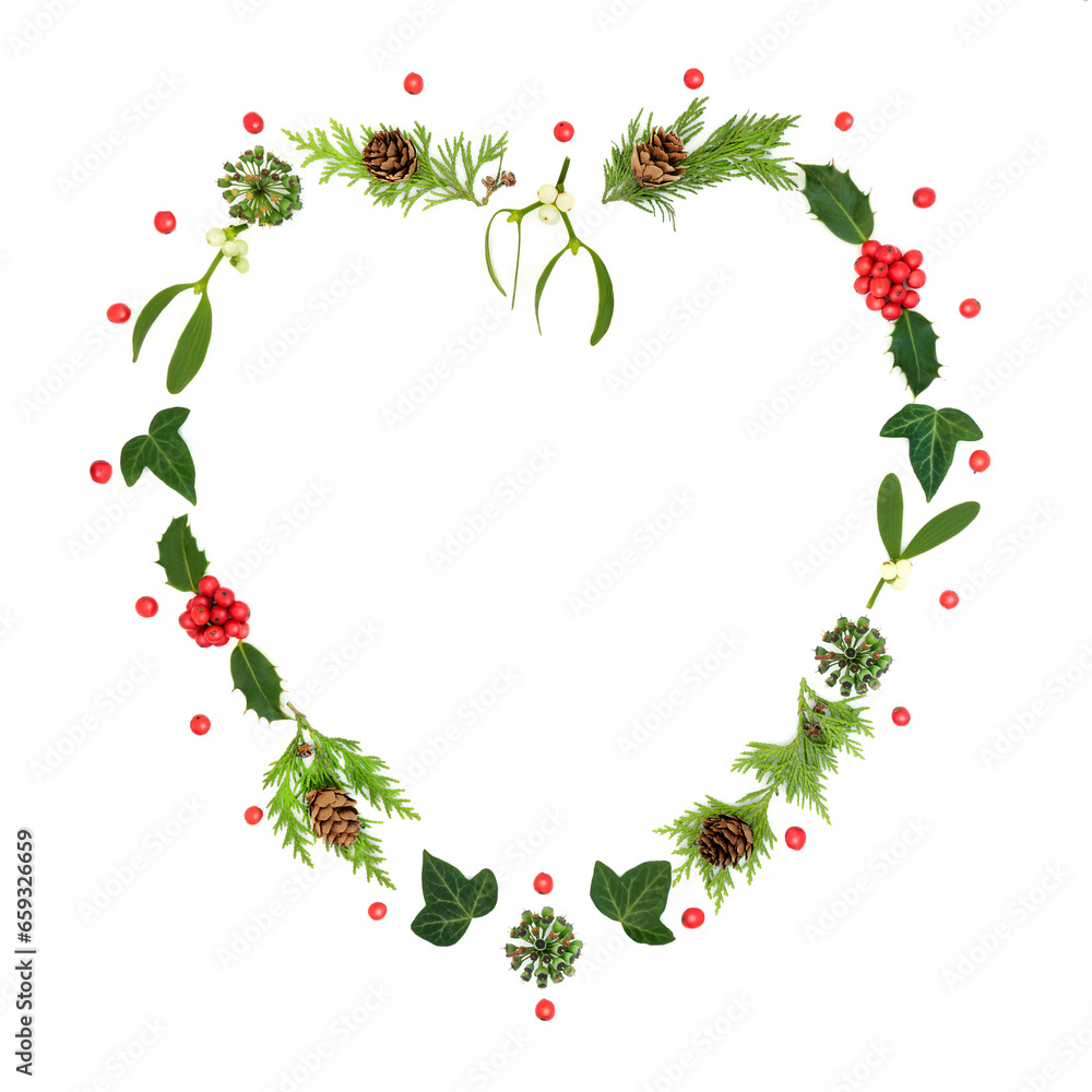 Romantic Christmas heart shape wreath with holly, mistletoe and winter greenery. Traditional nature symbol for the festive holiday season on white background. Romantic Christmas heart shape wreath with holly, mistletoe and winter greenery. Traditional nature symbol for the festive holiday season on white background.